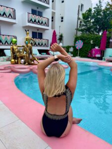 Sam sat on the edge of the pool at Wi-Ki-Woo Hotel in Ibiza.