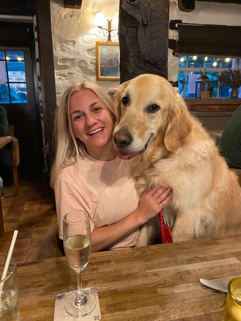 Woman and golden retriever in pub