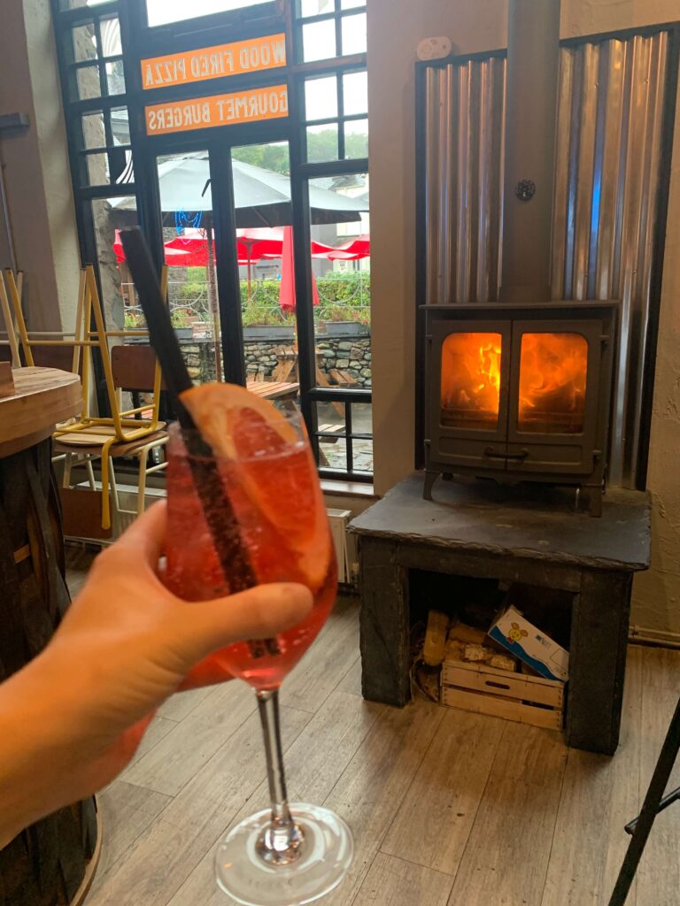 Blood orange spritz in front of woodburner