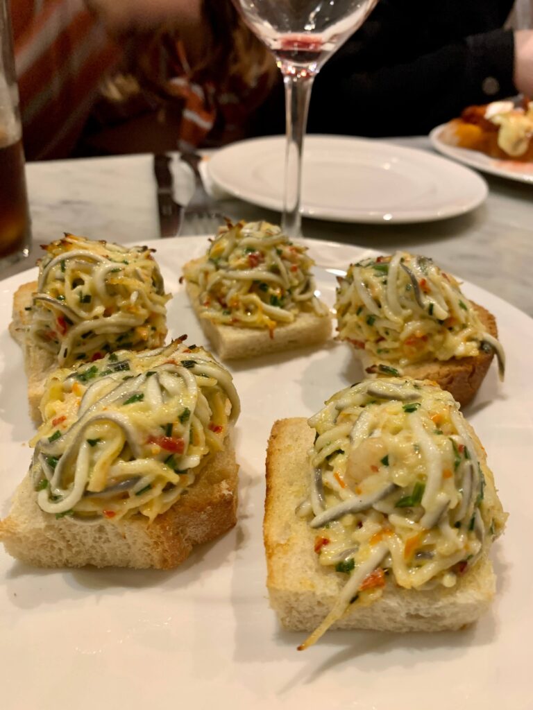 Scrambled eggs and baby eels on toast