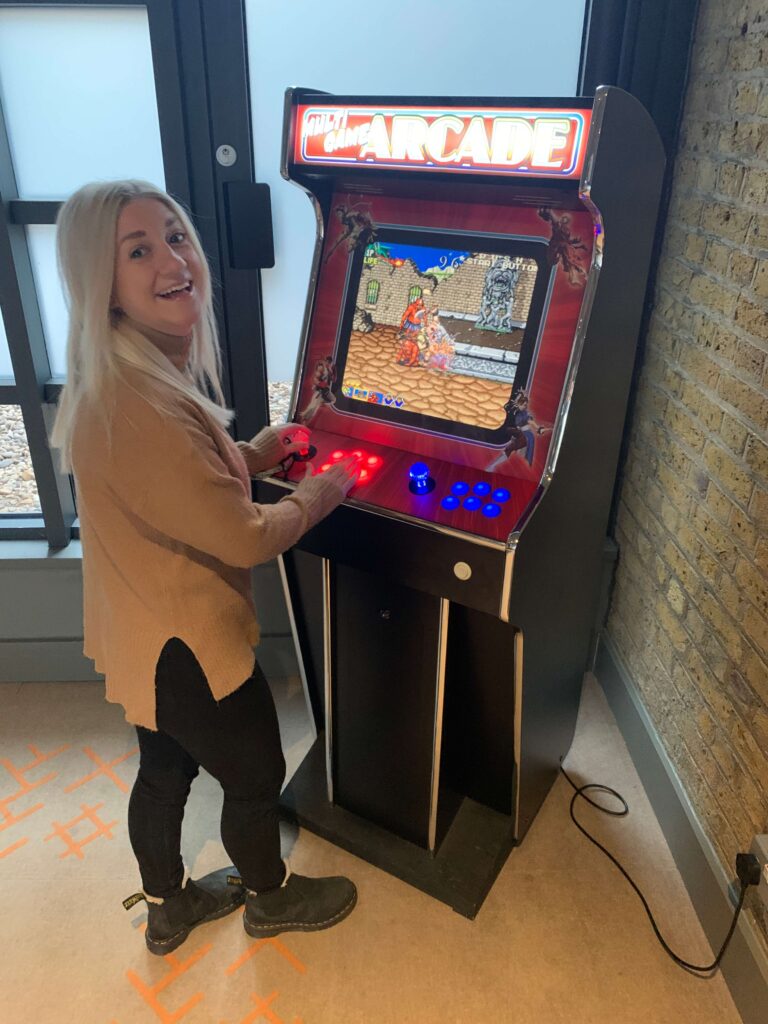 Woman playing arcade game
