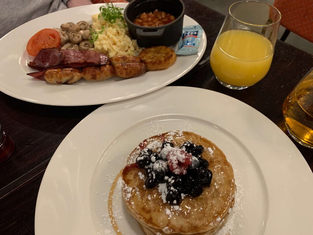 Pancakes with berries and a full English breakfast