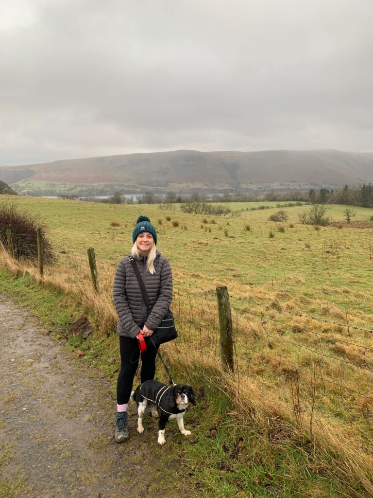 Woman and her small dog walking in the Lake District