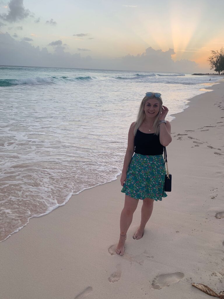 Woman standing on the shore at Dover Beach at sunset