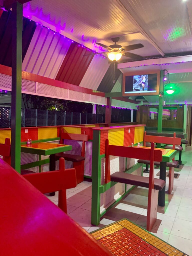 Colourful bar area with tables and stools