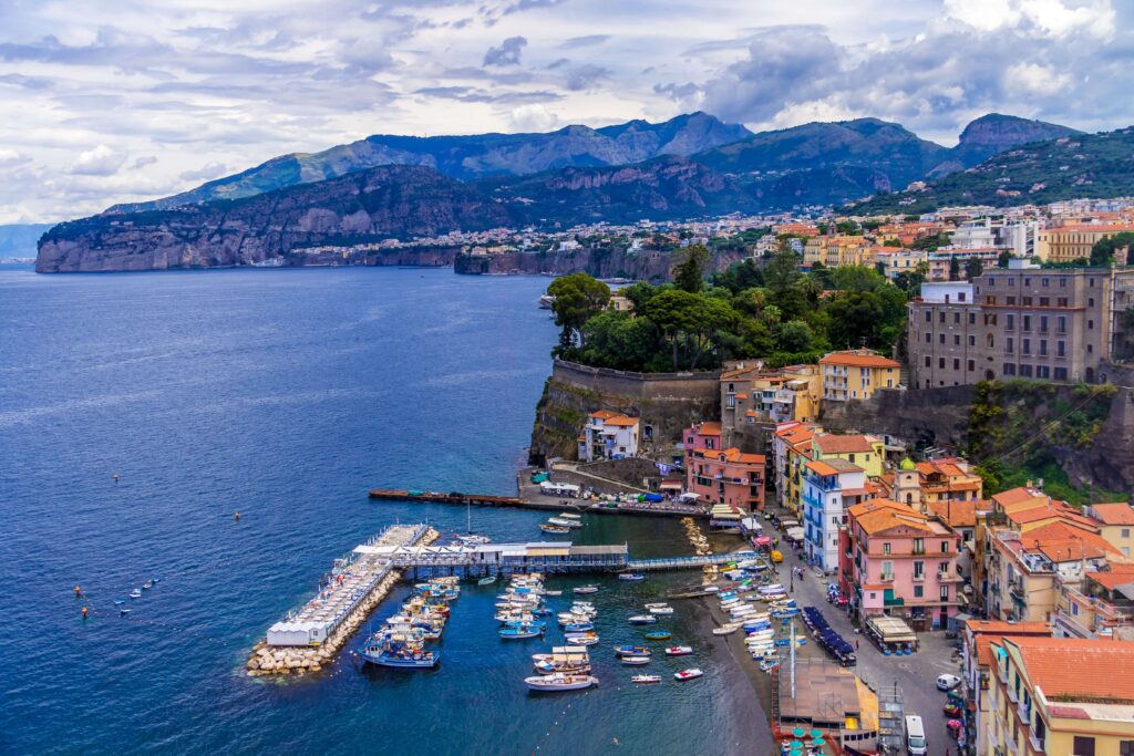 Sorrento with the coat and harbour in the foreground, surrounded by mountains behind