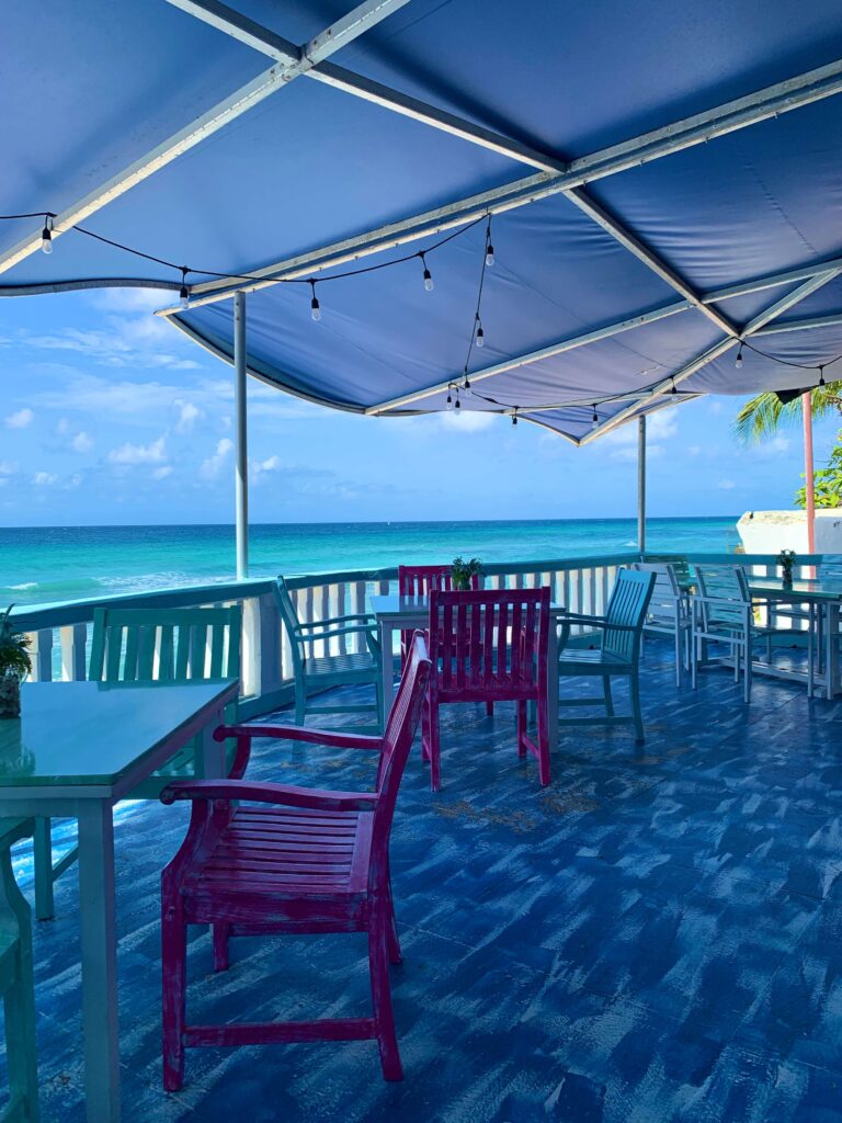 The terrace overlooking the Caribbean sea at Mimosas, St Lawrence Gap