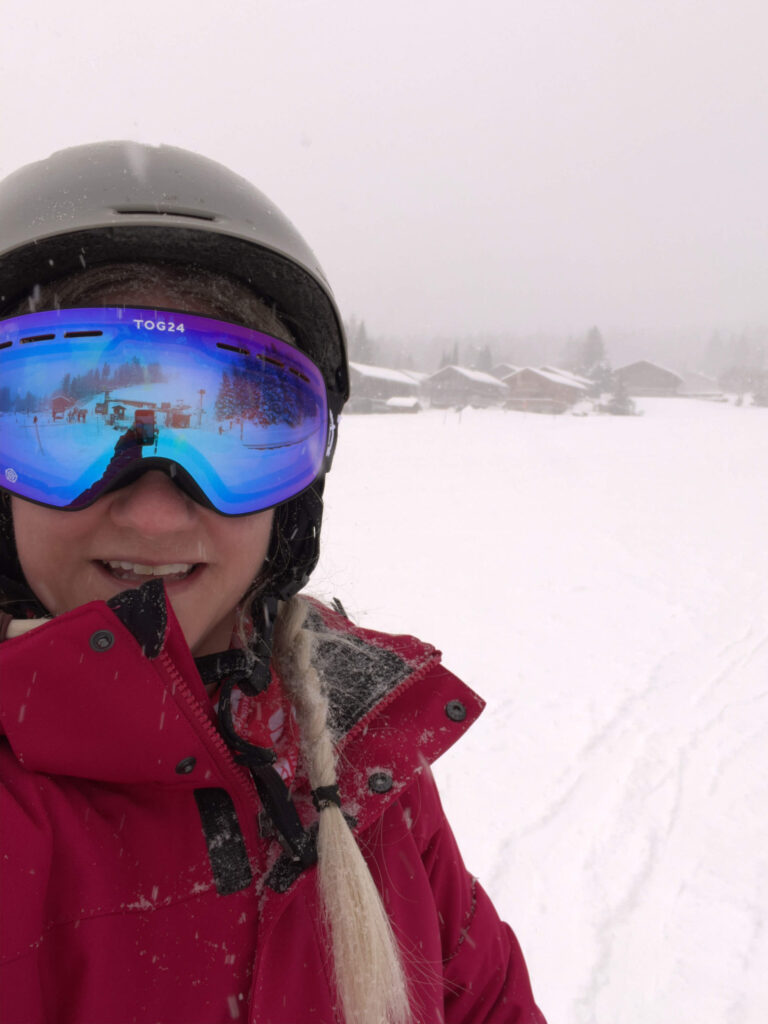 Close up of Sam wearing a ski helmet and goggles.