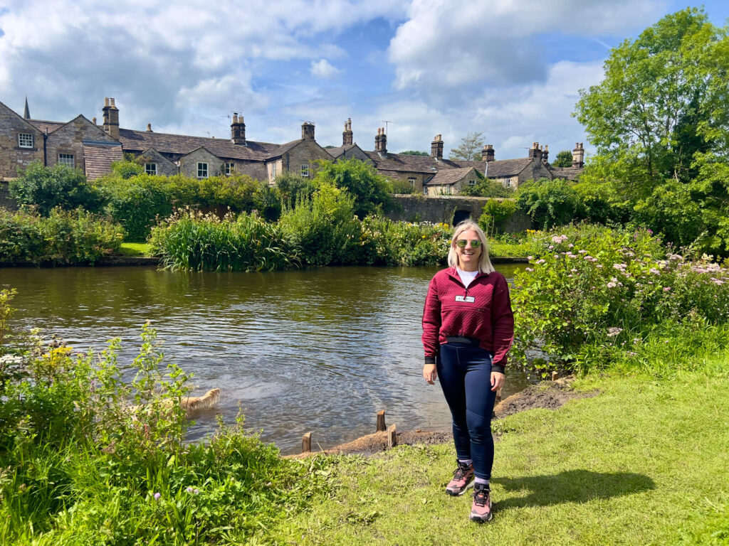 Sam poses in front of the River Wye in Bakewell wearing adidas TERREX gear.