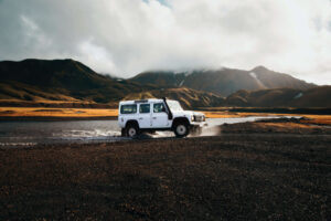 A 4x4 vehicle drives through Landmannalaugar in Iceland.