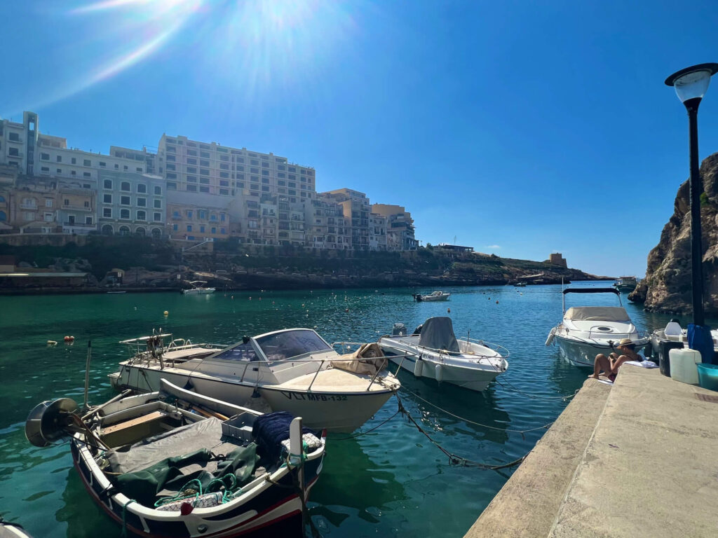 Small boats moored up at the Xlendi harbour in Gozo, Malta.