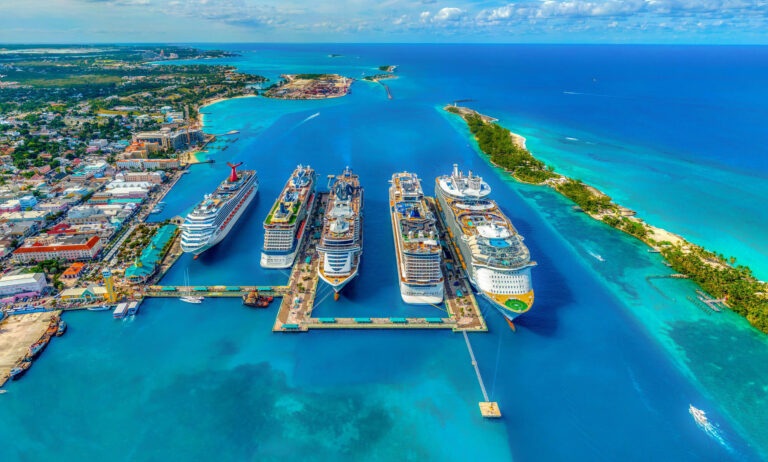 An aerial view of five cruise ships docked in the port in the Bahamas.