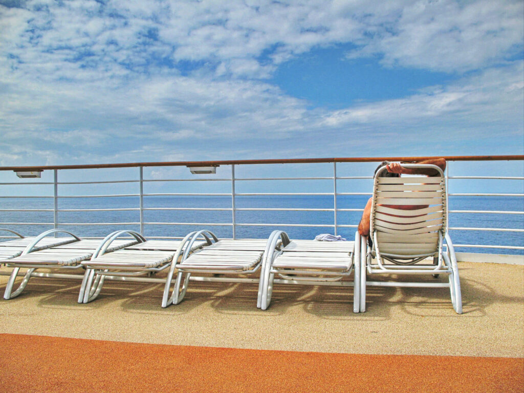 A row of sun beds on the deck of a cruise ship.