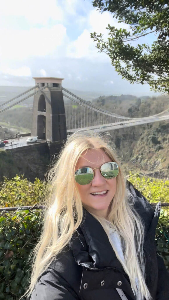 Sam taking a selfie with a view of the Clifton Suspension Bridge below.