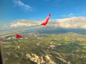 The view out of an aeroplane window over Paphos with a Jet2 wing.