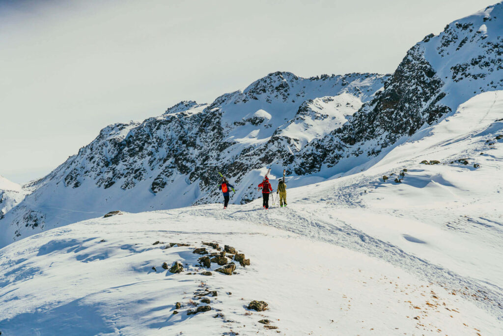 Three people hiking through the snow in Austria.