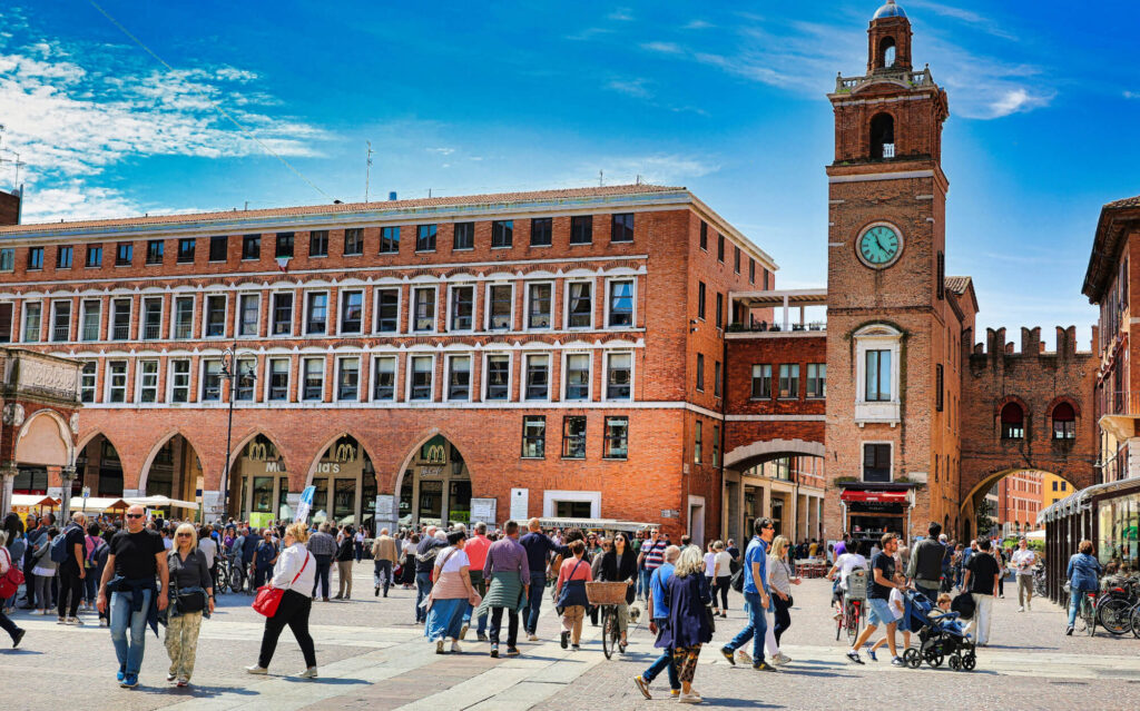 A building with a clock tower in Ferrara, Italy.