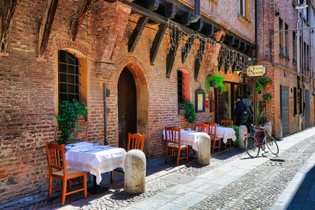 Tables and chairs outside a restaurant in Ferrara, Italy.