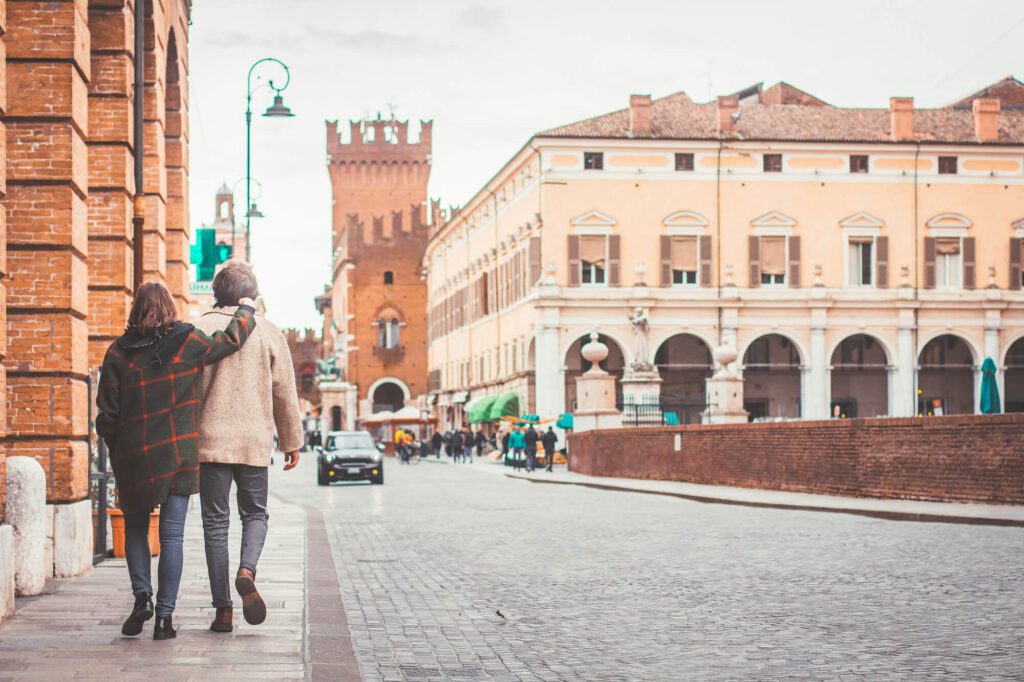 A couple walking through Ferrara in Italy.