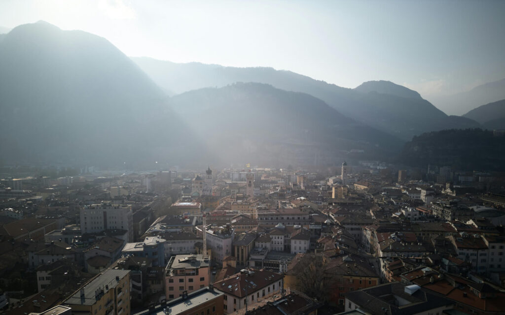 The sun's rays over Trento in Italy.