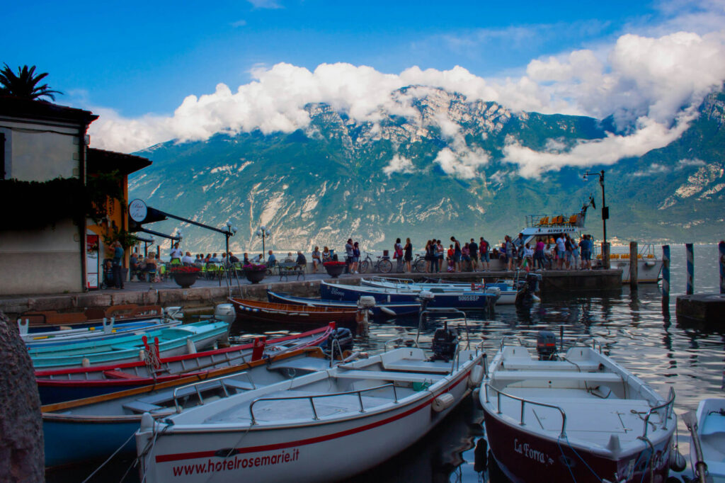 Boats on Lake Garda with mountains in the background.