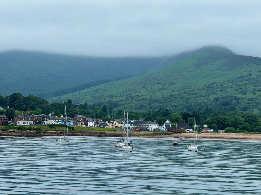 Boats in the sea on the coastline of Arran.