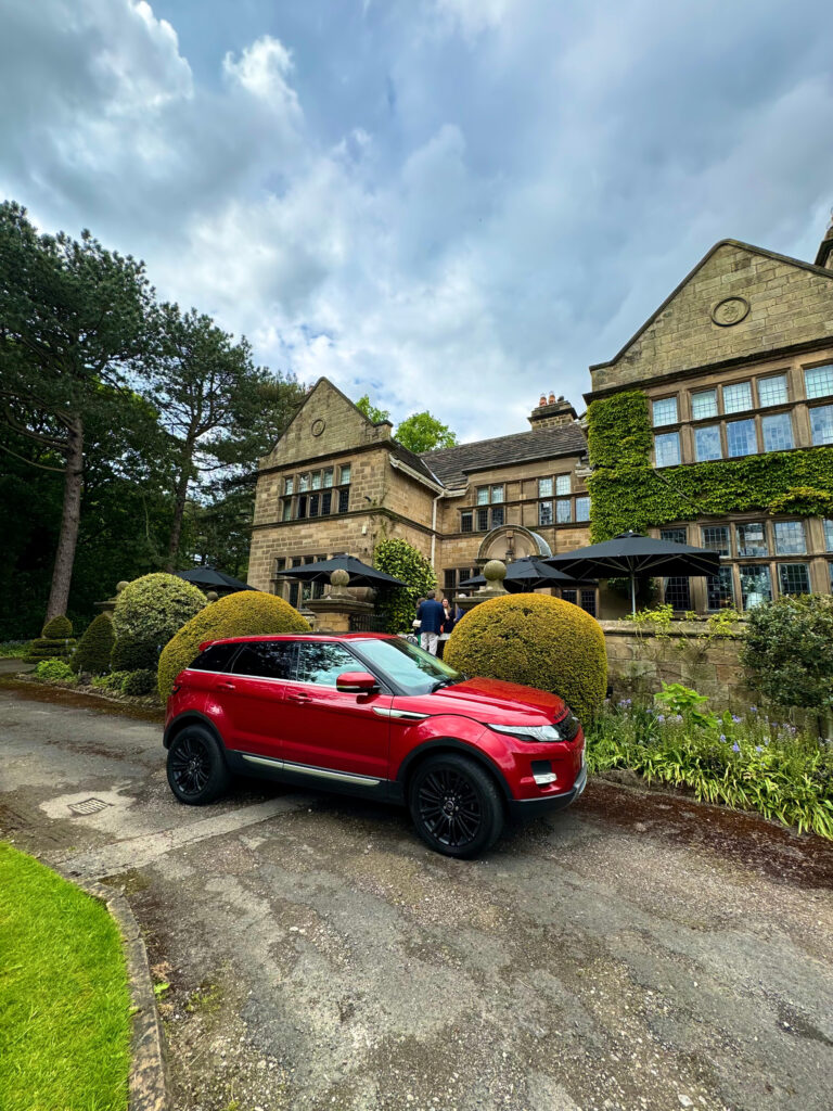 A red Range Rover parked outside Fischers in Baslow.