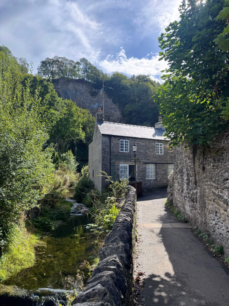 A pretty house on a river in the village of Castleton in the Peak District.