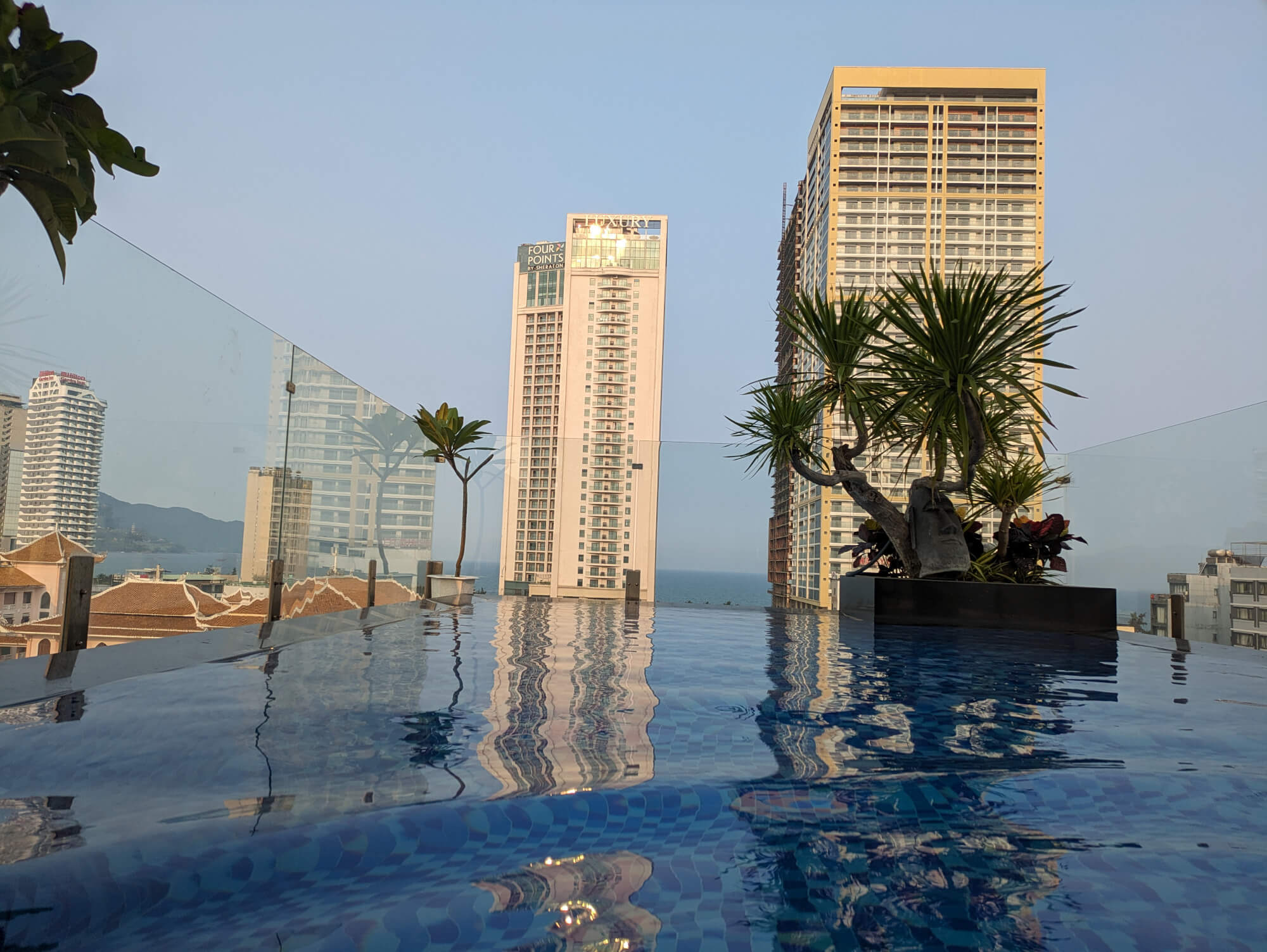 The rooftop pool and the view of Da Nang beyond it at the Tashi Ocean Hotel & Apartment.