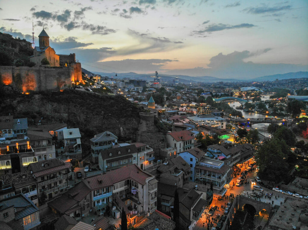 A hillside in Tbilisi at night time.