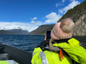 Sam wearing a bobble hat on a RIB tour in Norway.
