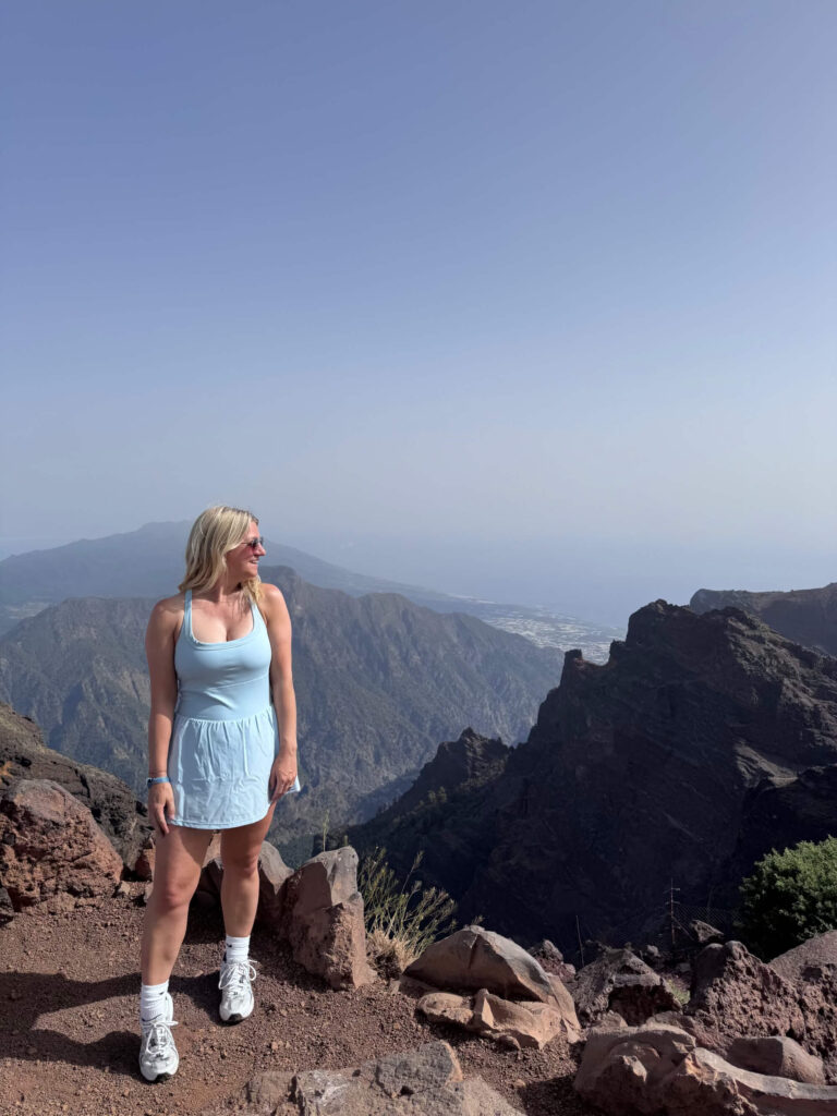 Sam standing in front of the mountains at the Roque de los Muchachos viewpoint.