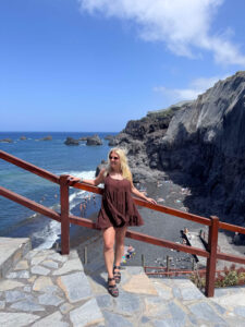Sam standing in front of a black sand beach in La Palma.